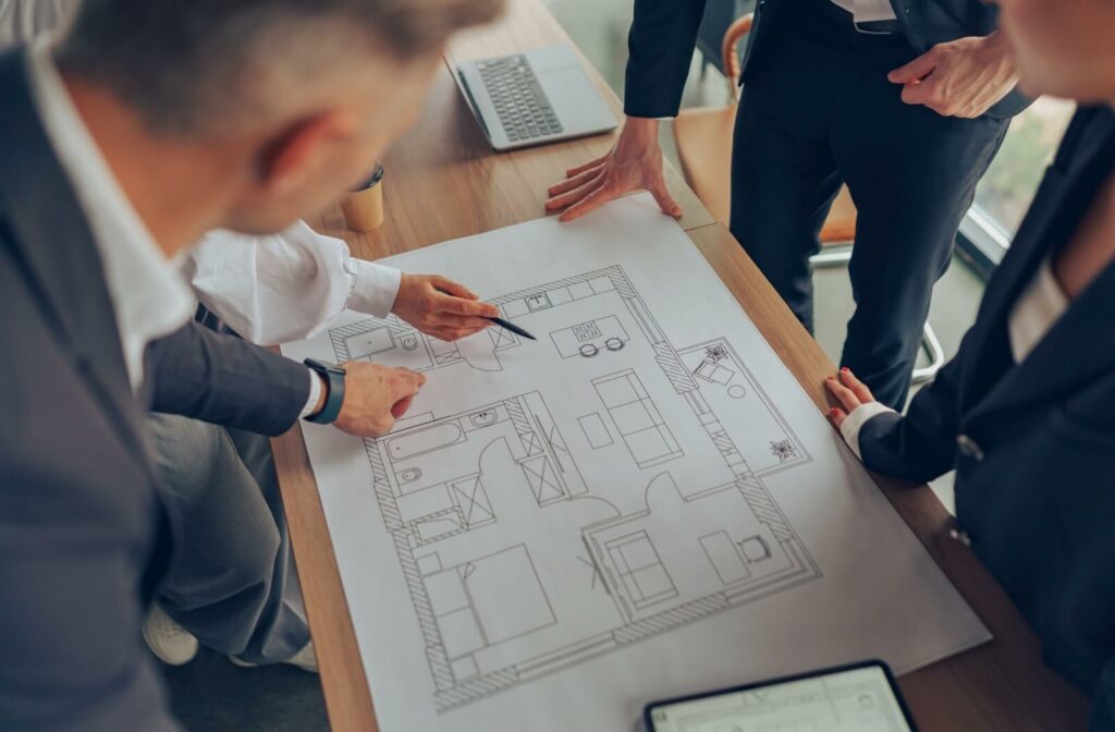 A close-up of professional business managers working with project documents that will revitalize an existing community.